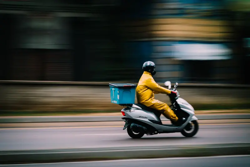 A rider on a scooter delivering an order