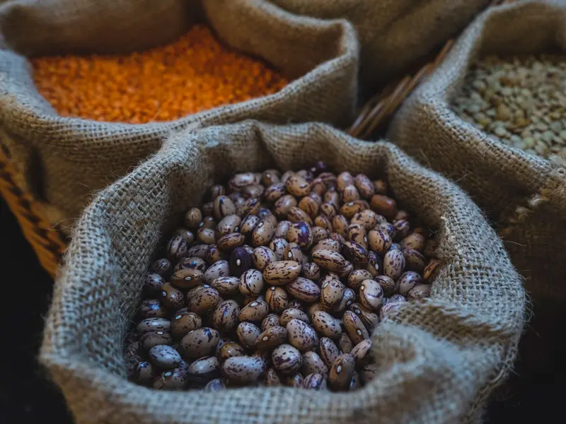 Open sacks of loose daal and chana at a kiryana counter